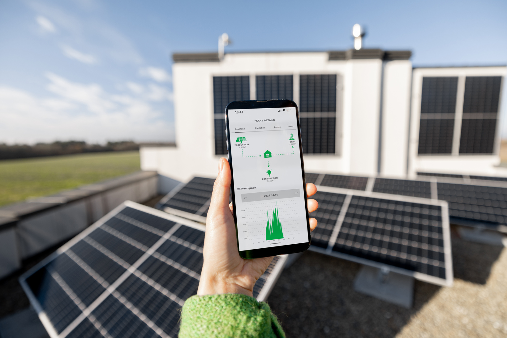 Woman Monitoring Solar Energy Production from a Smartphone